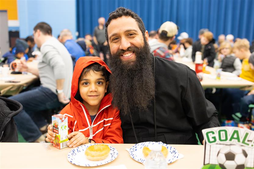 Trinity Elementary students eat donuts with dudes